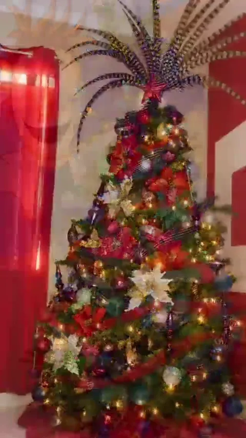 Red Christmas tree with dramatic feather topper