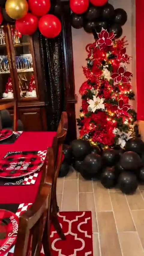 Red and black Christmas tree with balloon garland